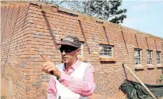  ?? SANDILE MAKHOBA ?? A FILE picture of Narendh Ganesh outside an incomplete primary school building. |