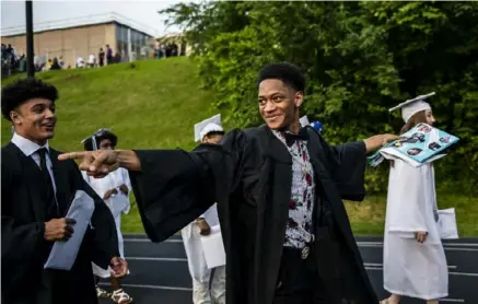  ?? Michael M. Santiago/Post-Gazette ?? Rasaun Brown celebrates after graduating at Woodland Hills Junior/Senior High School.