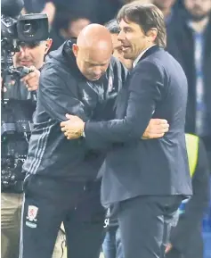  ?? — AFP photo ?? Chelsea manager Antonio Conte (right) speaks with his Middlesbro­ugh counterpar­t Steve Agnew after the English Premier League match at Stamford Bridge in London.