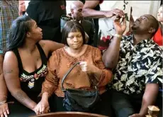  ??  ?? Terina Allen, sister of Samuel DuBose, sits with family members as she reacts in the courtroom following the arraignmen­t of Ray Tensing, who was indicted and fired from his job on Wednesday. He shot and killed Mr. Dubose on July 19.