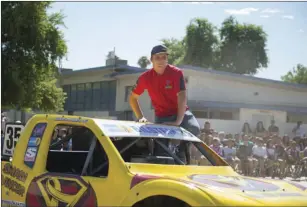  ??  ?? Mamer presents to Meadows Union School District students his Pro-lite class truck, which is covered with the winning design by seventh-grader Elliot Ortiz, for a design contest based around childhood cancer awareness on Wednesday in El Centro. VINCENT...