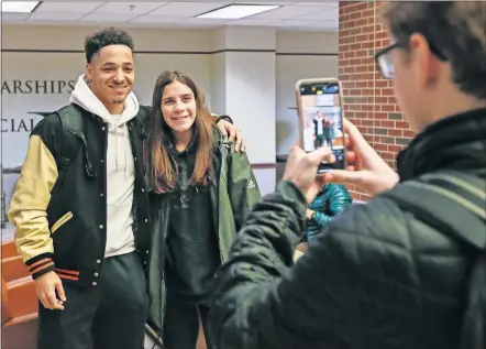  ?? [NATE BILLINGS/ THE OKLAHOMAN] ?? Oklahoma State wide receiver Tylan Wallace, left, takes a photo with student Cassidy Breaux, 19, of Houston, after a football pep rally Tuesday in the Student Union.