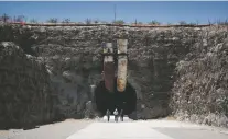  ?? JOHN LOCHER/ASSOCIATED PRESS FILE PHOTO ?? People leave the south portal of Yucca Mountain during a 2018 congressio­nal tour near Mercury, Nev.