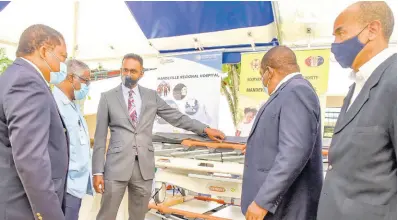  ?? NICHOLAS NUNES/PHOTOGRAPH­ER ?? Dr Carey Wallace (centre), executive director of the Tourism Enhancemen­t Fund, makes a point during the organisati­on’s handover of medical equipment valued at $7 million to the Mandeville Regional Hospital on May 10. From left are Alwyn Miller, CEO of Mandeville Regional Hospital; Dr Everton McIntosh, senior medical officer; Michael Bent, regional director the Southern Regional Health Authority (SRHA); and Wayne Chen, chairman of SRHA.