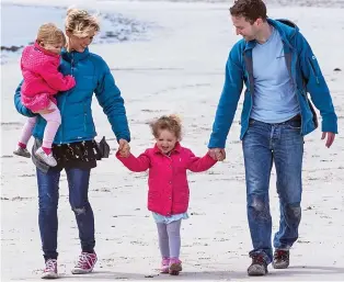  ??  ?? Idyllic lifestyle: A family on the beach at Rothieshol­m on Stronsay