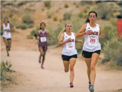  ?? NEW MEXICAN FILE PHOTOS BY JUAN ANTONIO LABRECHE ?? NOV. 4 Ella Katz, right, and the Taos High School cross country team ran away with the state title in a performanc­e that was the best in school history. Katz won the girls individual title.