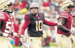  ?? SENTINEL STEPHEN M. DOWELL/ORLANDO ?? FSU quarterbac­k McKenzie Milton (10) directs players during the FSU Garnet & Gold spring game at Doak Campbell Stadium in Tallahasse­e on April 10.