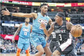  ?? [PHOTO BY BRYAN TERRY, THE OKLAHOMAN] ?? Washington’s Bradley Beal, right, tries to get past Oklahoma City’s Terrance Ferguson during the Thunder’s 116-98 loss Sunday to the Wizards at Chesapeake Energy Arena.