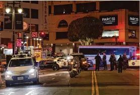  ?? Loren Elliott/Special to the Chronicle ?? Law enforcemen­t personnel work at the scene where a person was believed to be trapped underneath a Cruise vehicle in downtown San Francisco on Oct. 2.