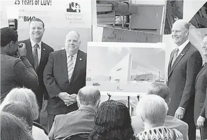  ?? MEREDITH COHN/BALTIMORE SUN ?? Gov. Larry Hogan, left, and Gary Kelly, Southwest Airlines chairman and CEO, flank an artist’s rendering of the airline’s proposed hangar at Baltimore-Washington Internatio­nal Thurgood Marshall Airport. Constructi­on is expected to begin next year.