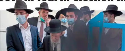  ?? Photo: Nampa/AFP ?? Crucial poll… Israel’s Rabbi Yerachmiel Gershon Edelstein (centre) is helped at a polling station to cast his vote in the mostly Jewish ultra-Orthodox city of Bnei Brak.