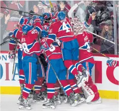  ??  ?? OVERTIME HERO: Members of the Montreal Canadiens pile on teammate Alexander Radulov after he scored the winning goal against the New York Rangers.