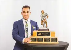  ??  ?? Jayden Halbgewach­s with the Bob Clarke Trophy, presented to the Western Hockey League’s top scorer, at the recent WHL Awards Banquet.