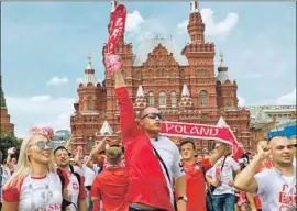  ?? Oleg Nikishin Getty Images ?? FANS celebrate before the Polish team’s match against Senegal last week. “Everyone’s here, everyone’s enjoying themselves,” said one reveler.
