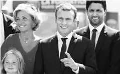  ?? PHOTO: REUTERS ?? French President Emmanuel Macron ( centre) gave his Cabinet ministers two weeks off along with instructio­ns to remain within striking distance of Paris in case of emergency