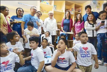  ?? BOY SANTOS ?? Quezon City Vice Mayor Joy Belmonte (fourth from right) interacts with children during the formal opening of the Kabahagi Resource Center for Children with Disabiliti­es yesterday. With her are Quezon City Rep. Feliciano Belmonte, Taguig Rep. Pia Cayetano and civic leader Mikey Belmonte.