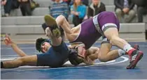  ?? ?? Mount Saint Joseph’s Coleman Nogle, right, works to pin Gilman’s Vinay Maheshwari in the first period of their 126-pound match on Wednesday.