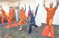  ??  ?? Volunteer Allison Merlo helps run a yoga class offered by the Prison Yoga Project Phoenix.