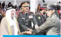  ??  ?? His Highness the Amir Sheikh Sabah Al-Ahmad Al-Jaber Al-Sabah receives a sword gifted to him by a newly-graduated army officer.