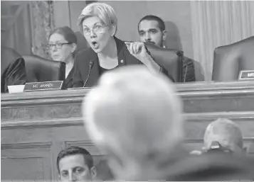  ?? SUSAN WALSH AP ?? Senate Banking Committee member Sen. Elizabeth Warren, D- Mass., center, grills Wells Fargo CEO John Stumpf, foreground, on Capitol Hill on Tuesday.