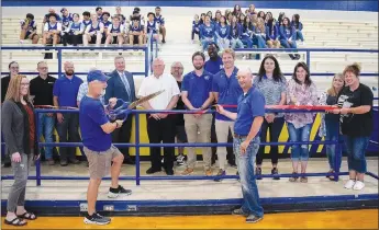  ?? Westside Eagle Observer/MIKE ECKELS ?? Ike Owens (second from left) cuts the ribbon, formally opening the newly renovated Peterson Gym at Decatur High School on Aug. 11. After the ceremony, the Decatur School Board voted to change the name of the gym to Ike Owens Fieldhouse.