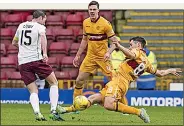  ??  ?? SORE ONE TO TAKE: McHugh (right) saw red for this tackle on Cowie, a decision that Motherwell boss McGhee will appeal