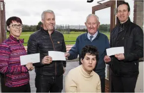  ?? Photo by John Reidy ?? Oileán Be representa­tives Seán Hanley (left) and Noreen McGuire (front) receiving their group’s cut from the 2017 Christmas Morning GOAL Mile Fundraiser from organiser Denis Brosnan, An Ríocht AC instructor Tara Walmsley and club committee treasurer, Bill Costello. The Kerry Hospice Foundation and Goal’s overseas operations also benefited from the event.