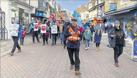  ?? ?? Protesters marching through the centre of Canterbury in the latest strikes, and below right, teachers Jack Marsh and Poppy Jones