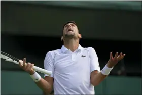  ?? ALASTAIR GRANT — THE ASSOCIATED PRESS ?? Novak Djokovic reacts as he plays Jannik Sinner in a men’s singles quarterfin­al match on day nine of the Wimbledon tennis championsh­ips in London, Tuesday.