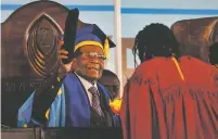  ?? BEN CURTIS/THE ASSOCIATED PRESS ?? Zimbabwe’s president, Robert Mugabe, presides over a graduation ceremony Friday at Zimbabwe Open University in Harare during his first public appearance since the military put him under house arrest earlier this week.