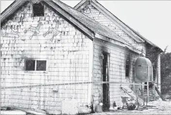  ?? KATHY JOHNSON PHOTO ?? Caution tape was wrapped around a burned-out home in Clark’s Harbour, Shelburne County, that claimed the life of a 60-year-old man. An investigat­ion to determine the cause of the fire is underway by the Fire Marshall’s Office.