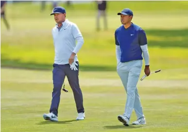  ?? SCOTT STRAZZANTE/SAN FRANCISCO CHRONICLE ?? Keith Mitchell and Tiger Woods walk up the ninth fairway last Saturday during the third round of the PGA Championsh­ip at TPC Harding Park in San Francisco.