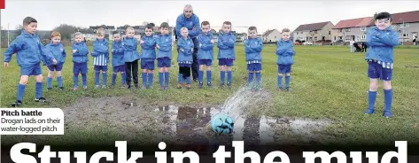  ??  ?? Pitch battle Drogan lads on their water- logged pitch