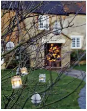  ??  ?? LIGHT THE WAY. Little glass lanterns and tree lights are hung in the garden by Lieset and her children, so as daylight starts to fadeto dusk, they light a pathway to the door for guests.