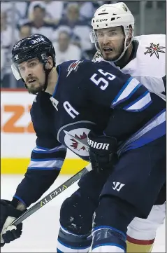  ?? KEVIN KING/POSTMEDIA NETWORK ?? Golden Knights’ Brayden McNabb (right) leans on Jets centre Mark Scheifele last night.