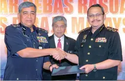  ?? ADIB RAWI YAHYA/ THESUN ?? Khalid (left) and MACC chief Datuk Dzulkifli Ahmad at the corruption-free pledge signing ceremony yesterday. Looking on is Deputy Prime Minister Datuk Seri Ahmad Zahid Hamidi.