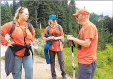  ?? COURTESY OF THERESA STURKIE ?? Theresa Sturkie (left) consults with Andrea Lankford and Aaron Samuel Wheeler during a 2020 search for a hiker in Washington state.
