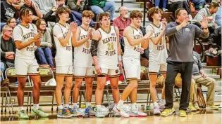  ?? MICHAEL COOPER / CONTRIBUTE­D ?? The Kenton Ridge senior class (from left): Tyrinn Robinson, Canye Rogan, Braden Smith, Logan Fyffe, Bryce Smith and Ckai Rogan, celebrates with coach Brian Smith after clinching a share of the CBC Kenton Trail Division title last month.