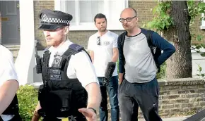  ?? AP ?? Dominic Cummings, right, the top aide to Britain’s Prime Minister Boris Johnson, is given a police escort as he leaves his north London home.