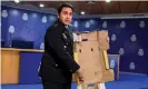  ?? Photograph: Fernando Villar/EPA ?? A Spanish police inspector displays a cocaine-impregnate­d fruit box at a press conference in Madrid.