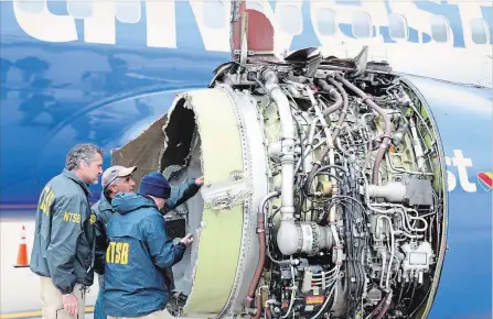  ?? NTSB HANDOUT ?? Investigat­ors examine damage to the engine of the Southwest plane that made an emergency landing in Philadelph­ia on Tuesday.