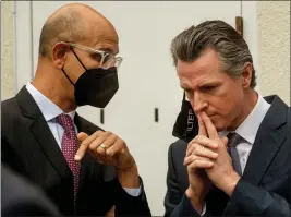  ?? KARL MONDON — BAY AREA NEWS GROUP ?? Gov. Gavin Newsom, right, confers with California Health & Human Services secretary Dr. Mark Ghaly before a media event on March 3, in San Jose.