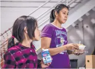  ?? ROBERTO E. ROSALES/JOURNAL ?? Sandra Cabelleros stands in the lunch line with her daughter Angelina, 8, at the former National Guard armory in Deming. Cabelleros was waiting on word about her 10-year-old daughter Alexandra, who was still in Border Patrol custody in Lordsburg.