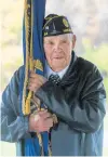  ?? ANDY LAVALLEY/ POST-TRIBUNE ?? American Legion Post 54 member Howard Strickler stands with the American Legion flag in Hobart.