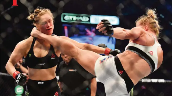  ?? — AFP ?? MELBOURNE: Holly Holm of the US (R) lands a kick to the neck to knock out compatriot Ronda Rousey and win the UFC title fight in Melbourne yesterday.