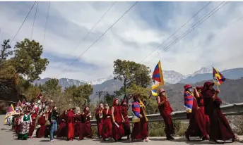  ?? — AFP photo ?? Tibetans living in exile in India attend a peace march during the 65th Tibetan National Uprising Day against the Chinese occupation of Tibet, in the suburb of McLeod Ganj near Dharamsala.
