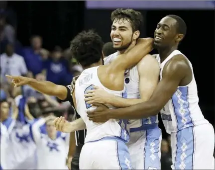  ?? MARK HUMPHREY — THE ASSOCIATED PRESS ?? North Carolina forward Luke Maye, center, celebrates with teammates after shooting the go-ahead basket with just 0.3 seconds remaining to beat Kentucky 75-73 in the South Regional final on Sunday and send the Tar Heels to the Final Four.