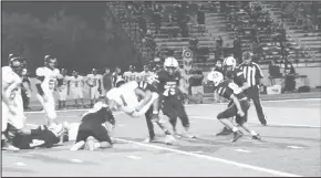  ?? HERALD Photos/shawn Moran ?? Above left: Stockton prepares to throw his first quarter touchdown strike to Cayden Morgan. Above right: A Forsan defender takes down a Wolves’ ball-carrier hard on a night where the Forsan defense was near impossible to move the ball against.