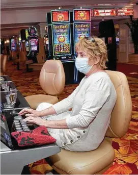  ?? Ethan Miller / Getty Images ?? Casinos in Las Vegas are open. But shows remain dark and convention­s have yet to return.
