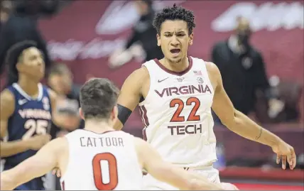  ?? Matt Gentry / Associated Press ?? Virginia Tech's Hunter Cattoor (0) and Keve Aluma celebrate a score against Virginia during the second half of their game Saturday. Aluma was 10-for-15 from the field and made a pair of 3-pointers for the Hokies.